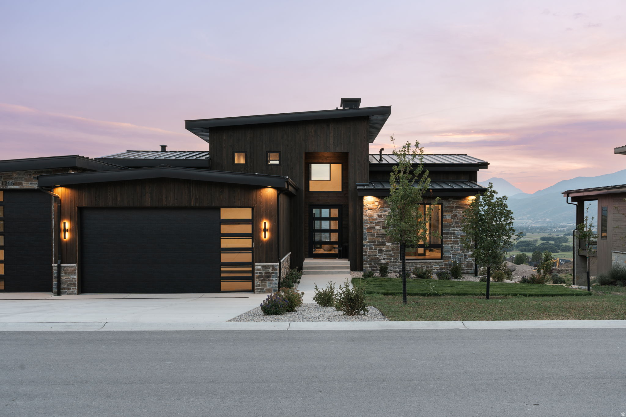 Modern architectural exterior featuring wood paneling and stone accents