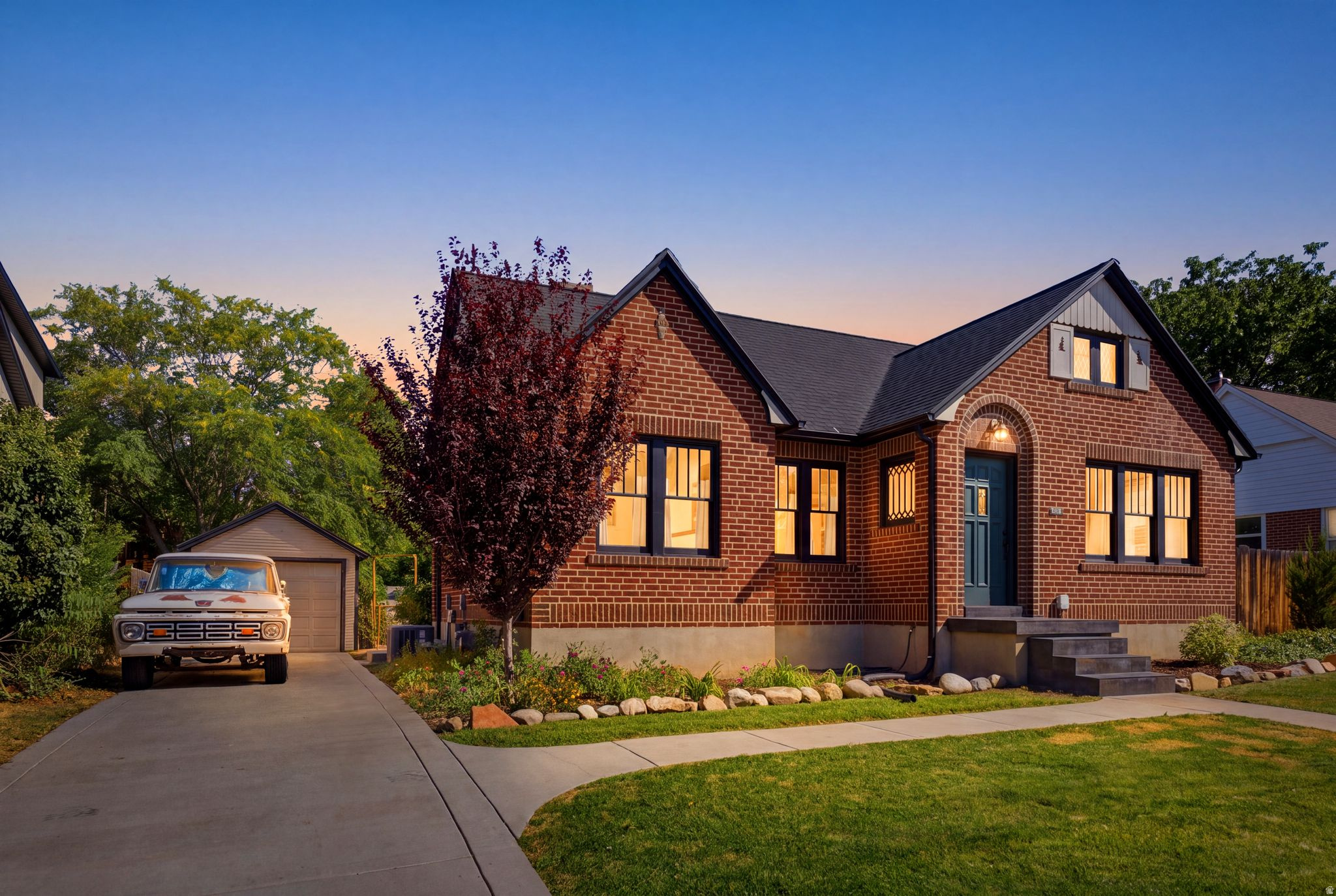 Brick exterior with a dark roof and a prominent front door