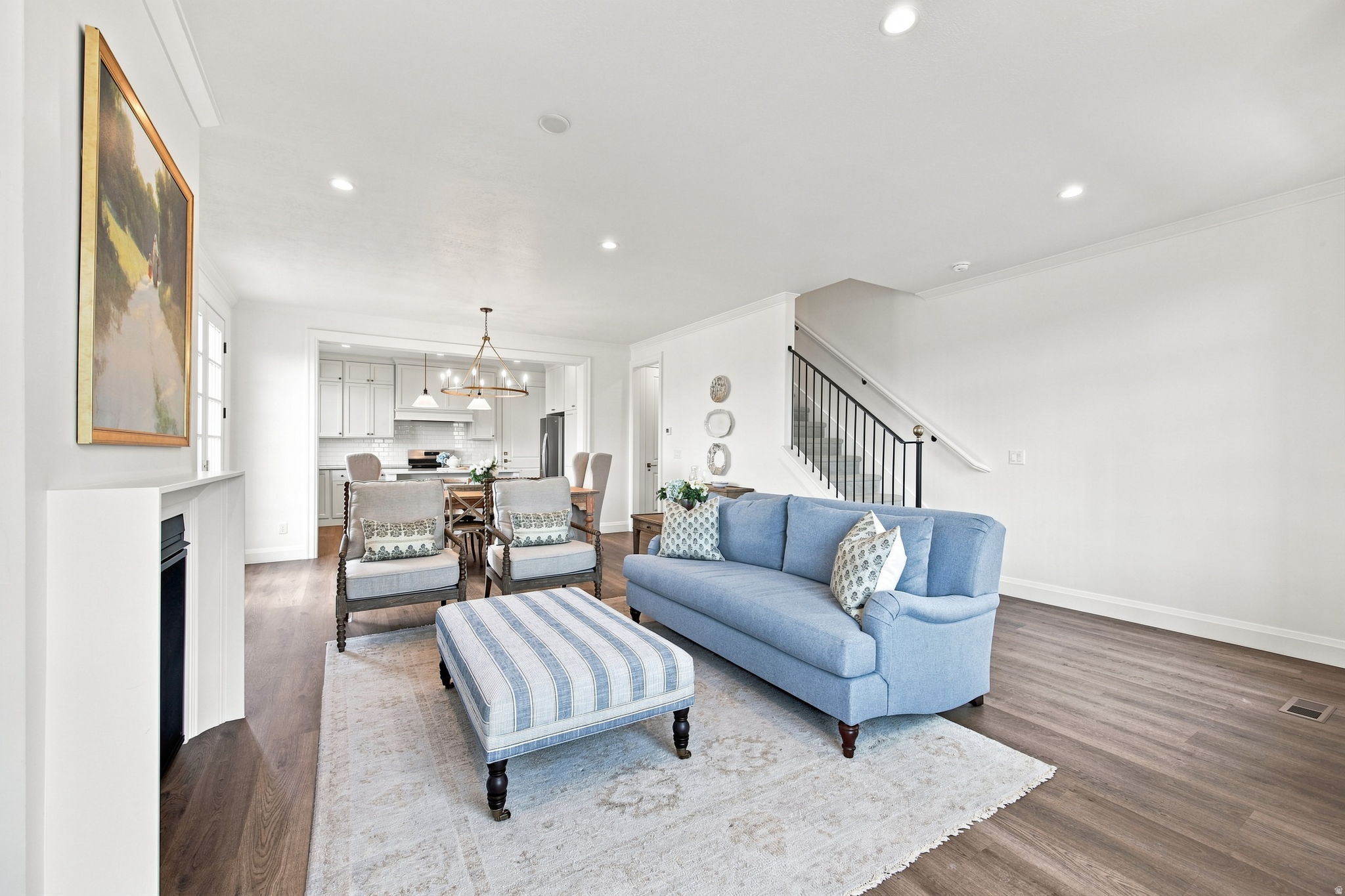 Model Home - Open-concept living area with wood-finish flooring, recessed lighting, and a built-in fireplace