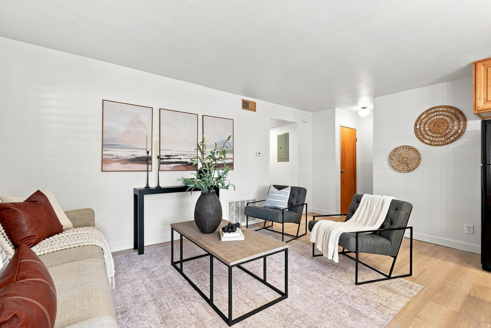 Light-toned wood-finish flooring, white walls, and recessed lighting create a bright interior