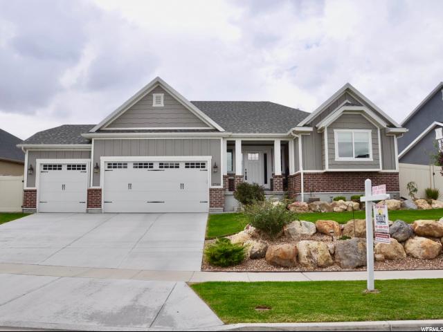 2739 WILDFLOWER DR S Saratoga Springs, Utah BACK ON THE MARKET! SALE FAILED DUE TO BUYERS INABILITY TO OBTAIN FINANCING. SOLAR PANELS ON HOME ~ Solar bill is approx. $9 per month! woohoo! BREATHTAKING LAKE VIEWS. This home features an open and updated kitchen with a large bar, granite countertops, and stainless steel appliances. Spacious living room with a cozy fireplace. Amazing main level master suite with walk-in closet, jetted tub, and separate shower. Attached 3 car garage with plenty of storage room. Outstanding backyard with beautiful landscaping and plenty of space to entertain. Enjoy the breathtaking views of the lake and mountains. This home is in an amazing community that features a pool, clubhouse, gym room, and spa. Square feet as per County. Buyer and Buyer's Broker to verify all information including square footage and acreage and solar utility costs Curtain in Living Room and Dining Room are excluded from the sale.