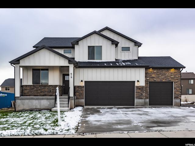 619 SAGE LN W 1600 Saratoga Springs, Utah You can search high and low and you won't find this quality in any new build for this price...beautiful, rich laminate hardwood floors, open and bright kitchen with white cabinets and granite/quartz countertops....lots of cabinet and counter space for entertaining. No corners cut on this home and it shows....upgrades galore. Exterior finishes of stone, board and baton, add just the right amount of texture and dimension to this stunning home. Home features upgraded carpet, high ceilings, vaults and a great stainless LG appliance package including fridge, soft water system, quartz bathrooms, tile shower surrounds, Euro- Glass shower enclosure in Master. Front yard landscaping completed in August, some of the pix are from before landscaping.