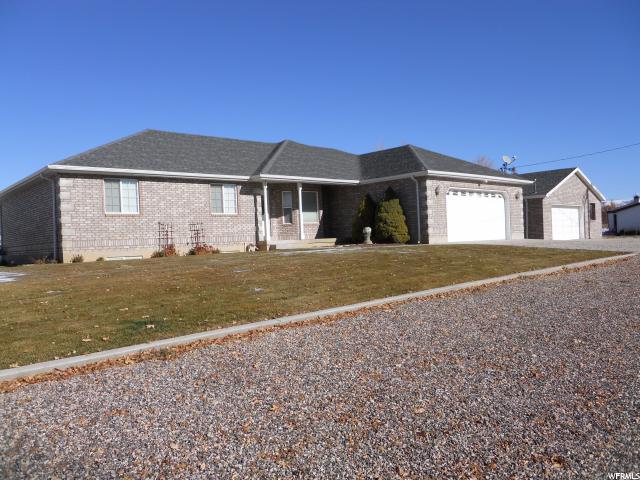 315 200 N E Moroni, Utah Beautiful custom built rambler on an Acre+ lot. Ideal layout for a basement accessory apartment or mother-in-law. Corner lot with easy access to side and rear of lot. Outbuildings: huge detached garage with lift, huge barn and small stall. This home has had one owner and the bones are in terrific shape.