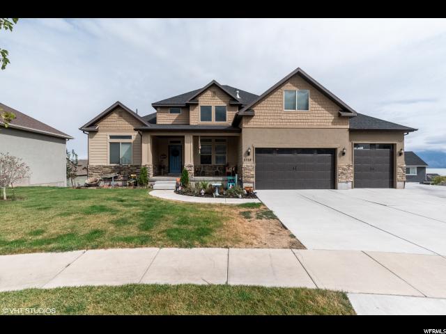 2728 LAVENDER LN W S Saratoga Springs, Utah This this home sits on a very friendly culdesac, with beautiful lake views. The yard is completely landscaped and includes an RV pad and fire pit. The front room has vaulted ceilings, creating a lot of light. The living room has windows to the ceiling, allowing you to enjoy the LAKE VIEWS and city lights at night. The kitchen has beautiful tile and granite countertops, all stainless steel appliances, with a double oven. The master bath features jack and jill sinks and a garden tub, with beautiful tile work. The basement has nine foot ceilings and is a walk out, showcasing lake views even from the basement floor. At 60% finished, it offers two bedrooms and a beautiful full bath. An enormous family room and open toy room or den area are steps from completion, but already feel warm and livable due to special touches. Every light has been updated with more modern and impressive fixtures. The home has solar power, paid off. Come take a look at this beautiful house in a prime location before it goes!