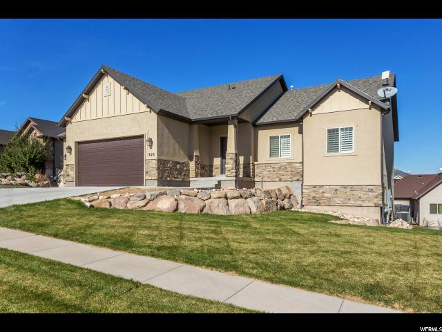 328 RUGER DR S W Saratoga Springs, Utah Just Listed and ready for it's new owner. Jump on it now before its gone. Beautiful 5 Bedroom/3 Bath home in the wonderful housing area of Jacobs Ranch. This home boasts over 3200 square feet, which is ALL finished living space including the newly finished, walkout basement, that offers a large family room, 2 bedrooms and full guest bath. The main floor of this home features 3 bedrooms, which includes a Master Bedroom and master bathroom with separate shower and tub, full large walk-in closet and more as well as a full guest bath. The remainder of the main level includes large family room with open concept floor plan with large stone fireplace, updated kitchen with granite counter tops, Stainless steel appliances, gas range, huge pantry and semi formal dining. Last but not least, the rest of this property includes a large deck made of Trex material to enjoy the views of Utah Lake as well as a 3 stall garage and added parking for several vehicles. Schedule your private showing today. Square footage figures are provided as a courtesy estimate only and were obtained from County records . Buyer is advised to obtain an independent measurement.