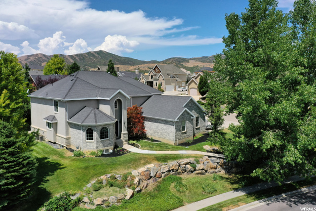 11579 MERCER HOLW Highland, Utah GRAND OPENING THIS SATURDAY 7/31 11 am-1 pm. Come see your beautiful home! Offering over 6500 square feet you will enjoy the benefits of the desirable DRY CREEK ESTATES. Nestled in the Highland East bench you are within walking distance to two PARKS and the renowned Ridgeline Elementary school. Plenty of storage from the 5 closets/cubbies off of the garage, to the oversized storage room in the basement, and all the extra built-in closet spaces. Close to everything: shopping, restaurants, entertainment, and easy access to I-15! There are plenty of features & benefits including, MAIN LEVEL LIVING- master on the main floor, large windows & natural light, vaulted ceilings, 3 car garage, separate BASEMENT ENTRY, with plumbing for a second kitchen and laundry room (mother-in-law/legal accessory opportunity), 2 fireplaces, two-toned paint, OPEN KITCHEN with Large WALK-IN PANTRY, double ovens, GRANITE counters, 2 HOME OFFICES (the one on the second floor has breathtaking mountain views), 4 bedroom and two Jack and Jill bathrooms on the second floor. Mature trees, with FRUIT TREES, 2 peach and a cherry tree, strawberry and blackberry bushes. Come take advantage of this huge home! And did we mention you will love the neighborhood?! Not only do you buy a HOME - you are buying the neighborhood. With the parks close by and the friendliness of the neighbors ... it will be the perfect place for YOUR FAMILY! Check out the VIRTUAL TOUR - http://utah-virtual-tours.scatterscape.com/?TourID=1758838