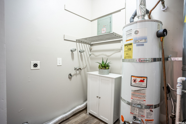 Laundry area with hanging shelf.