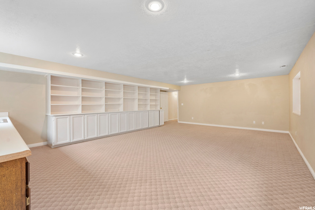 Huge family room with built-ins across one wall for books, games, and plenty of storage!