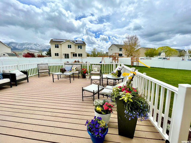 French doors open to large living space/deck outdoors.  Enjoy green grass & mountain views.