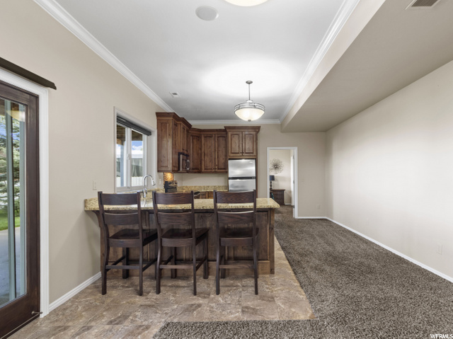 Basement kitchen area with walkout to the covered