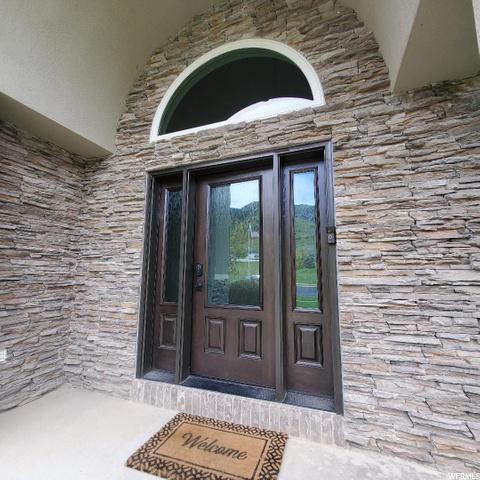 Covered entry has a new door with obscure glass