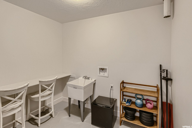 Basement laundry room with sink