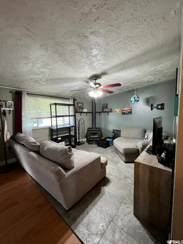 living room with view of wood burning fireplace