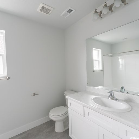 Bathroom with tile floors, oversized vanity, and mirror