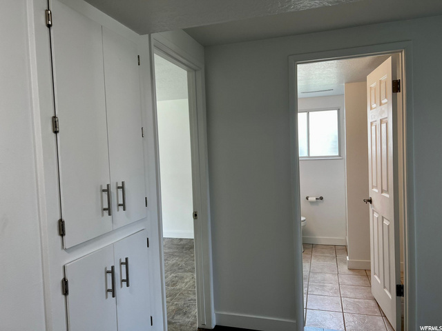 Hall way to Bathroom With Hall Cabinets