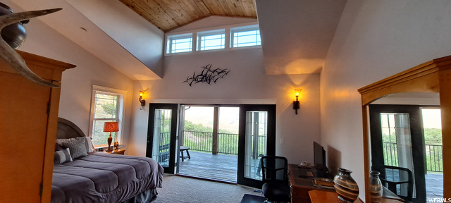 Main bedroom on main level includes 6 foot wide French doors out to the large 10x18 covered deck.