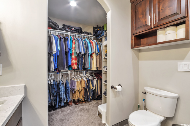 Primary bedroom walk-in closet