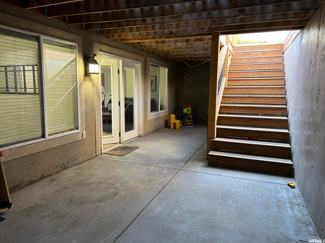 Stairs to basement entrance with lots of patio spa