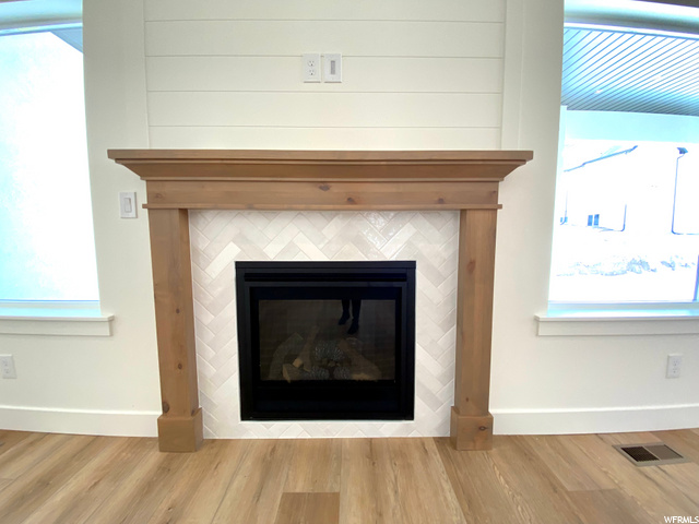 Upstairs fireplace: Tile surround, stained mantle & shiplap detail above.