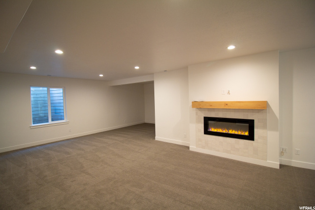 living room with a fireplace and carpet