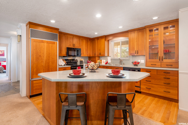 Large, open kitchen with island and bar