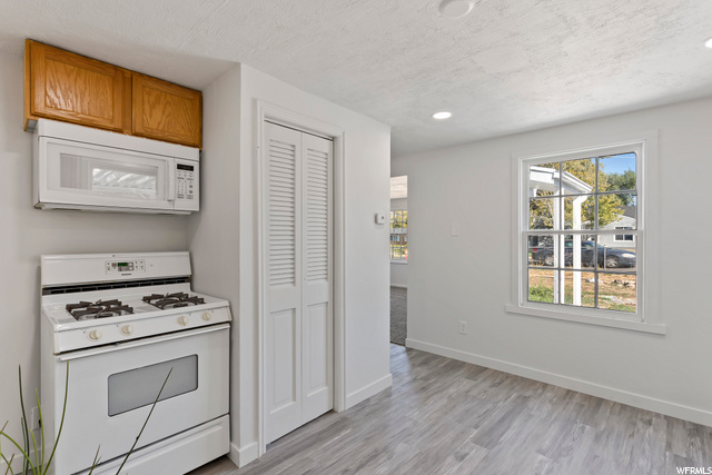 Kitchen w/ gas range and microwave