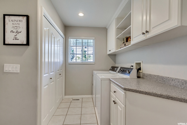 MAIN FLOOR LAUNDRY ROOM WITH TILE FLOOR