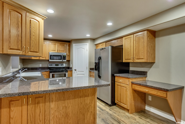 LOWER LEVEL KITCHEN WITH DESK AREA WITH WOOD FLOOR