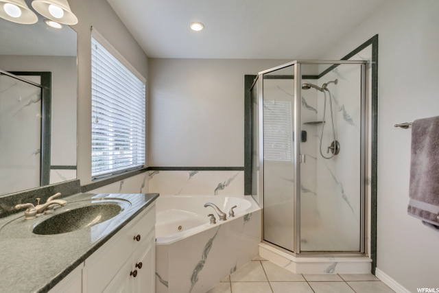 MASTER BATHROOMWITH TILE FLOORING