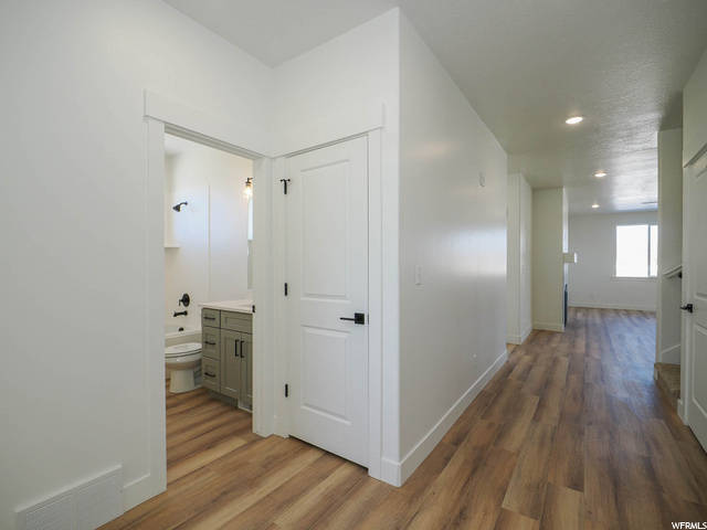 hallway with wood-type flooring