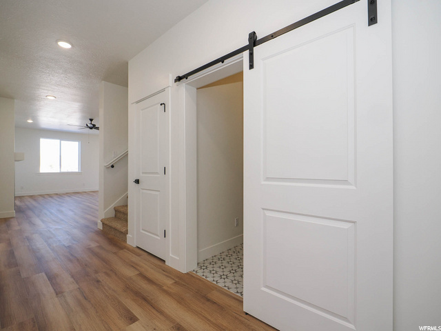 hallway featuring hardwood floors and natural light