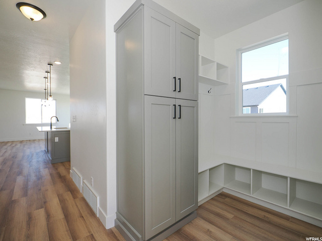 mudroom featuring natural light and hardwood flooring