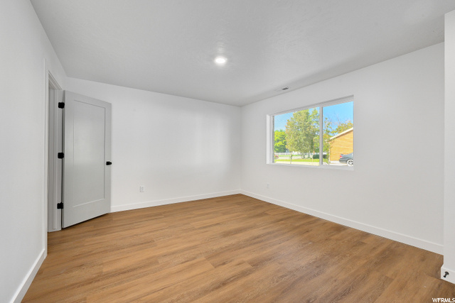 empty room with hardwood floors and natural light
