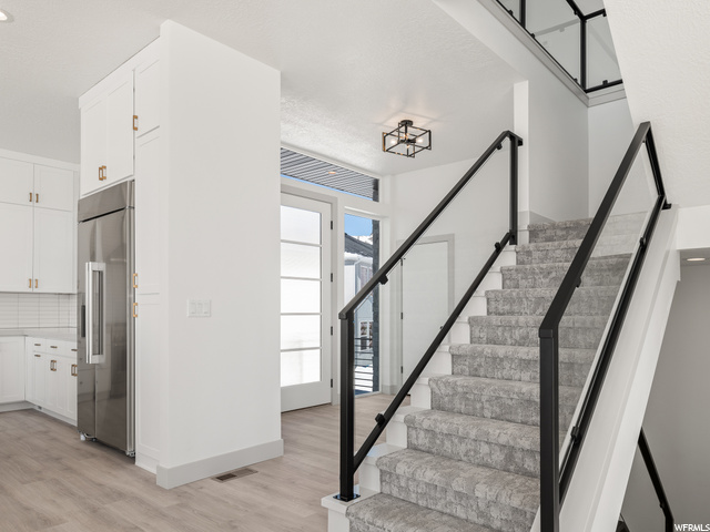 stairway with natural light and hardwood flooring