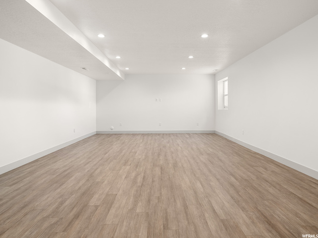 hardwood floored spare room with natural light