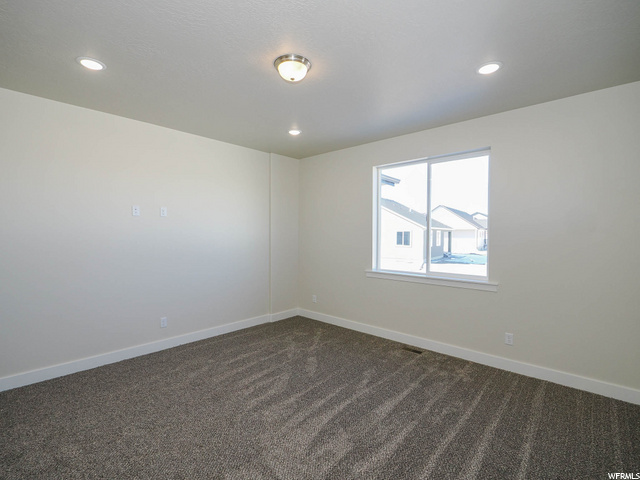 empty room with carpet and natural light