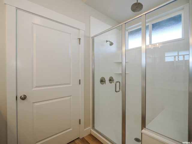 bathroom featuring shower with glass door