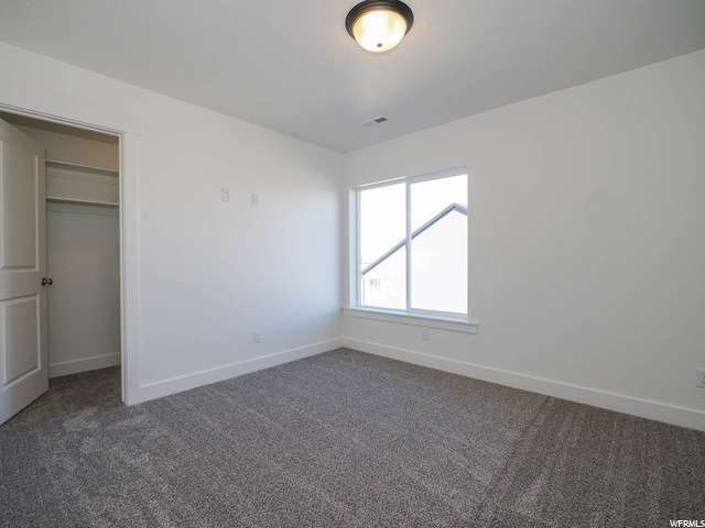 carpeted bedroom featuring natural light