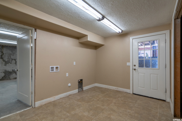Basement laundry room area and access to outside.