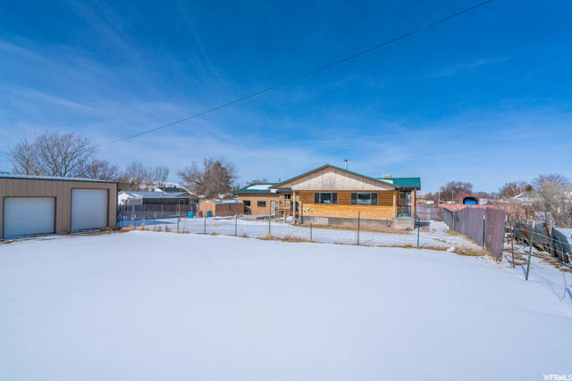 View from back of lot looking at the home and shop