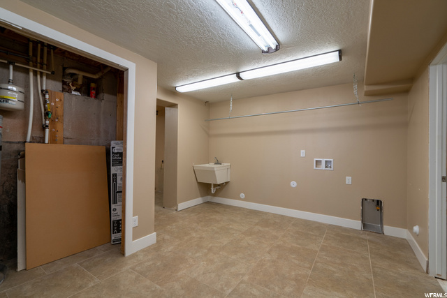 Basement laundry room area and access to outside.