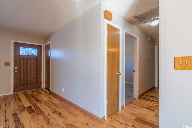 Entry leading to hallway and bedrooms/bathrooms