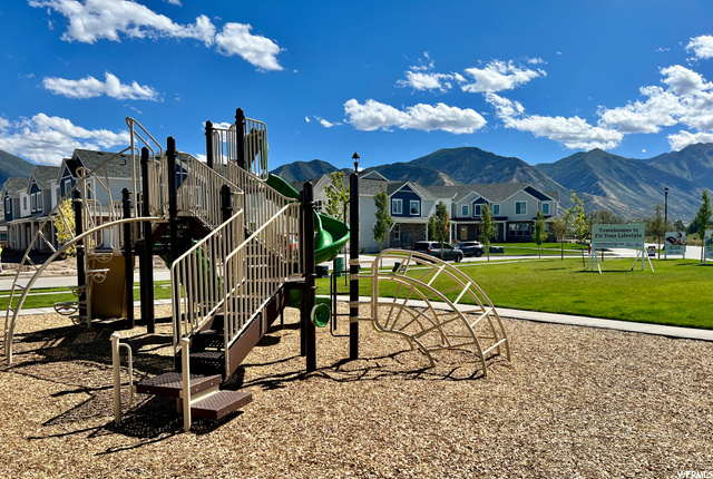 view of play area featuring a mountain view and a yard