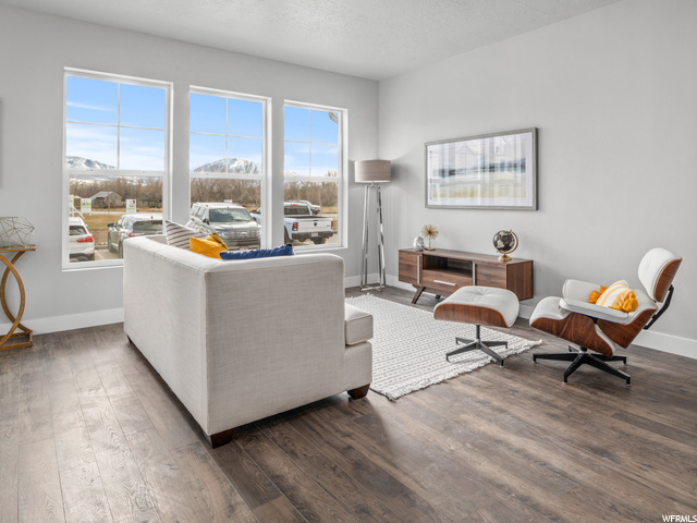 hardwood floored living room featuring plenty of natural light