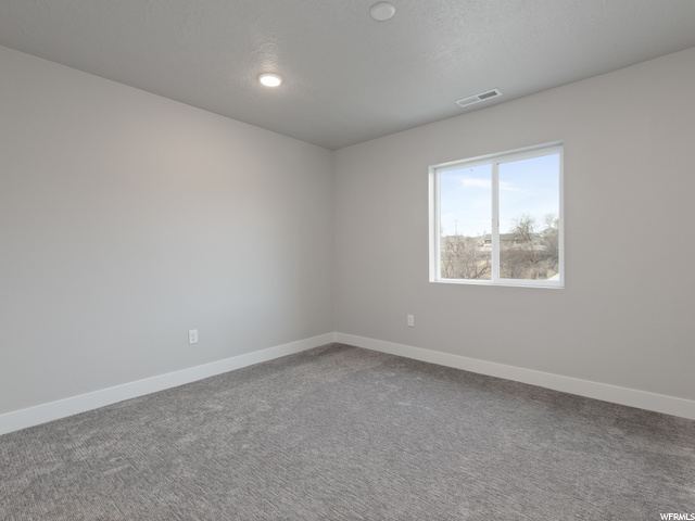 empty room with natural light and carpet