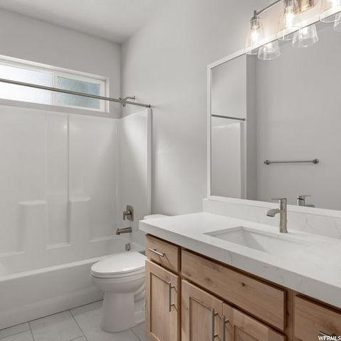 full bathroom featuring tile floors, toilet, vanity, bathing tub / shower combination, and mirror