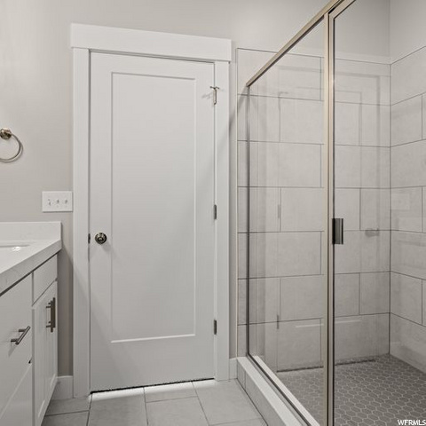 bathroom featuring vanity and enclosed shower