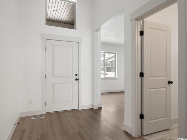 hallway featuring hardwood flooring and natural light