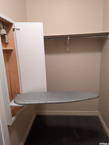 Main walk in closet built in ironing board