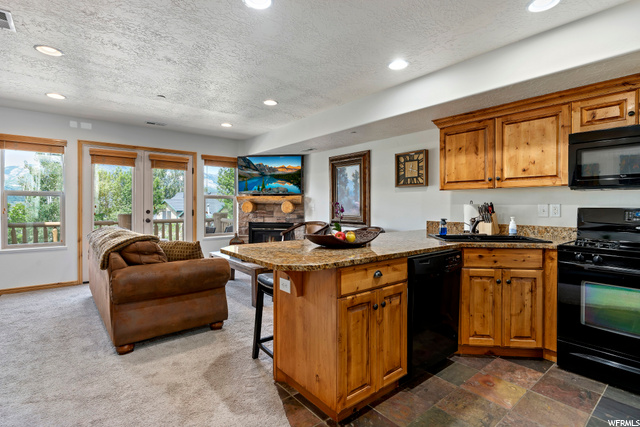 Granite countertops and knotty alder cabinets.